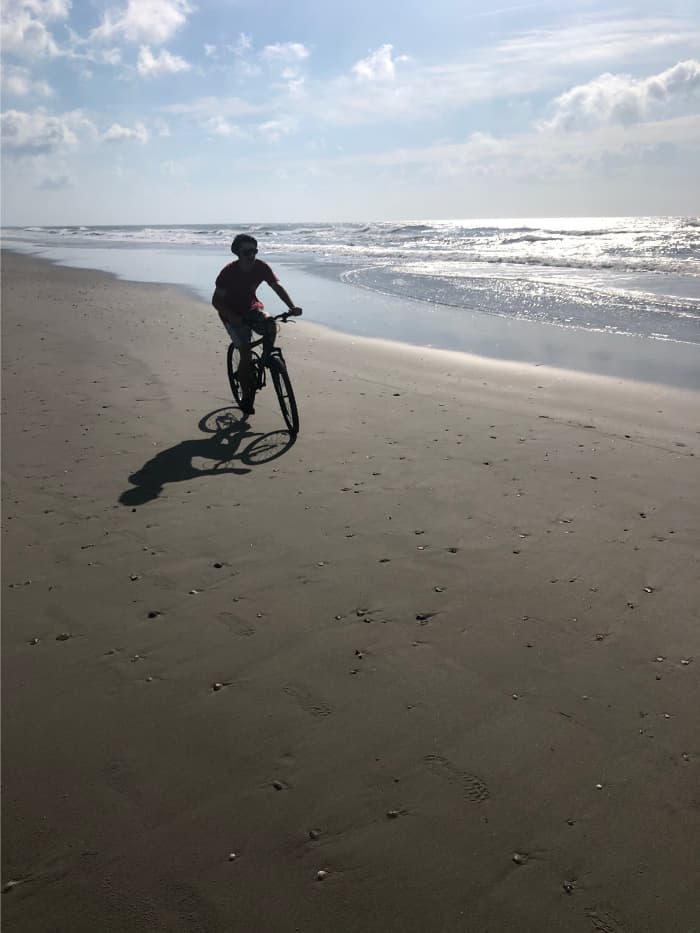 riding bikes on the beach is one way how to plan a vacation
