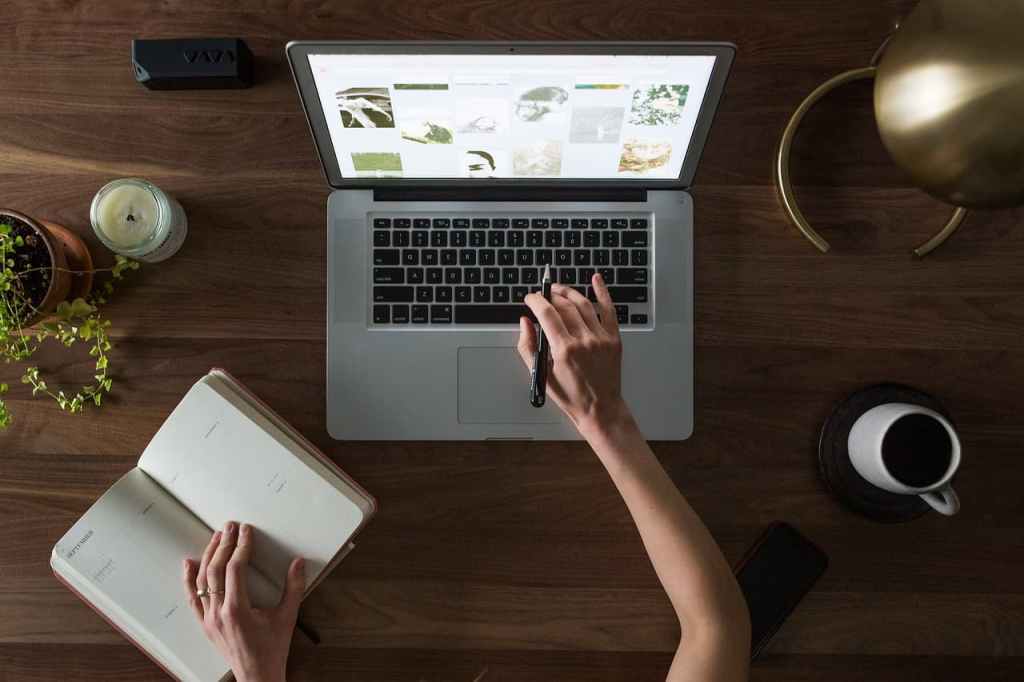 woman sitting at laptop researching supplements